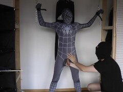 Ballbusting and electro on the balls of tied black Spiderman Thumb